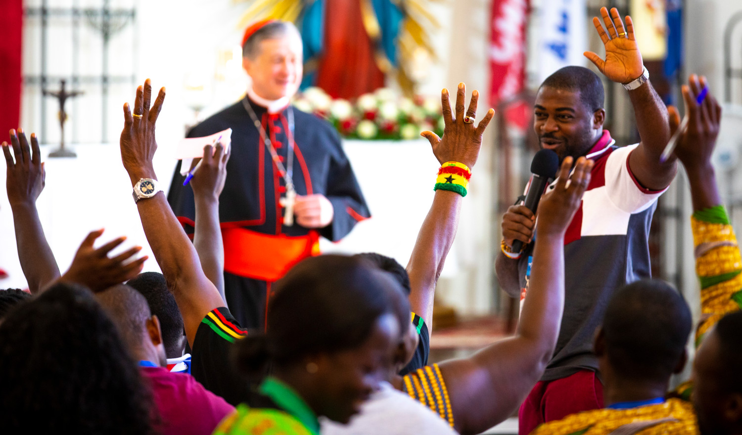 A pilgrim from Ghana asks others from his country to raise their hands during a World Youth Day catechesis session lead by Chicago Cardinal Blase J. Cupich at the Parish of Our Mother of Perpetual Help in Panama City Jan. 25, 2019.